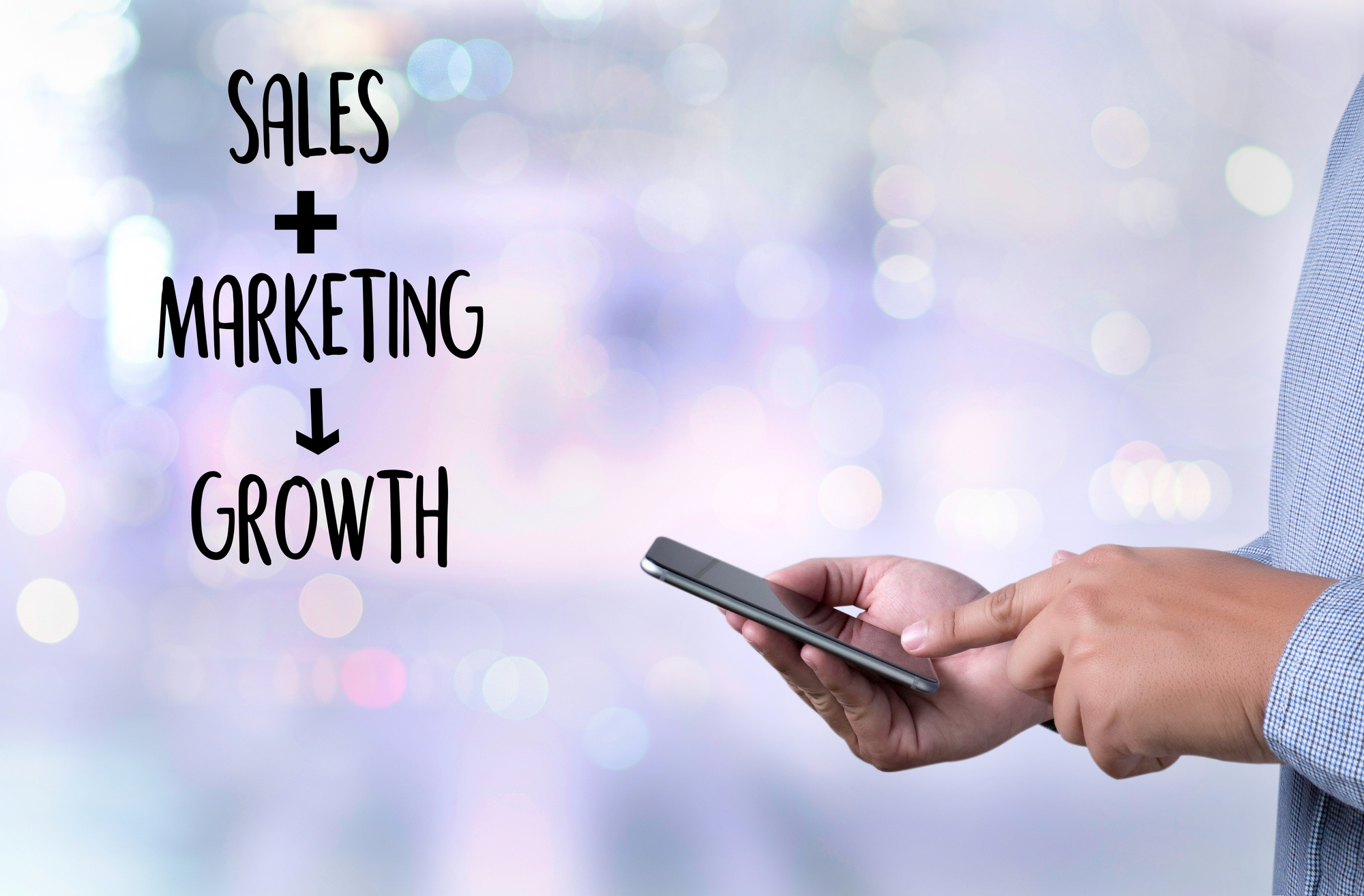 the words-sales-marketing-growth-and0image-of-hand-holding-smartphone